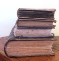 Four antique decorative books sold as a set