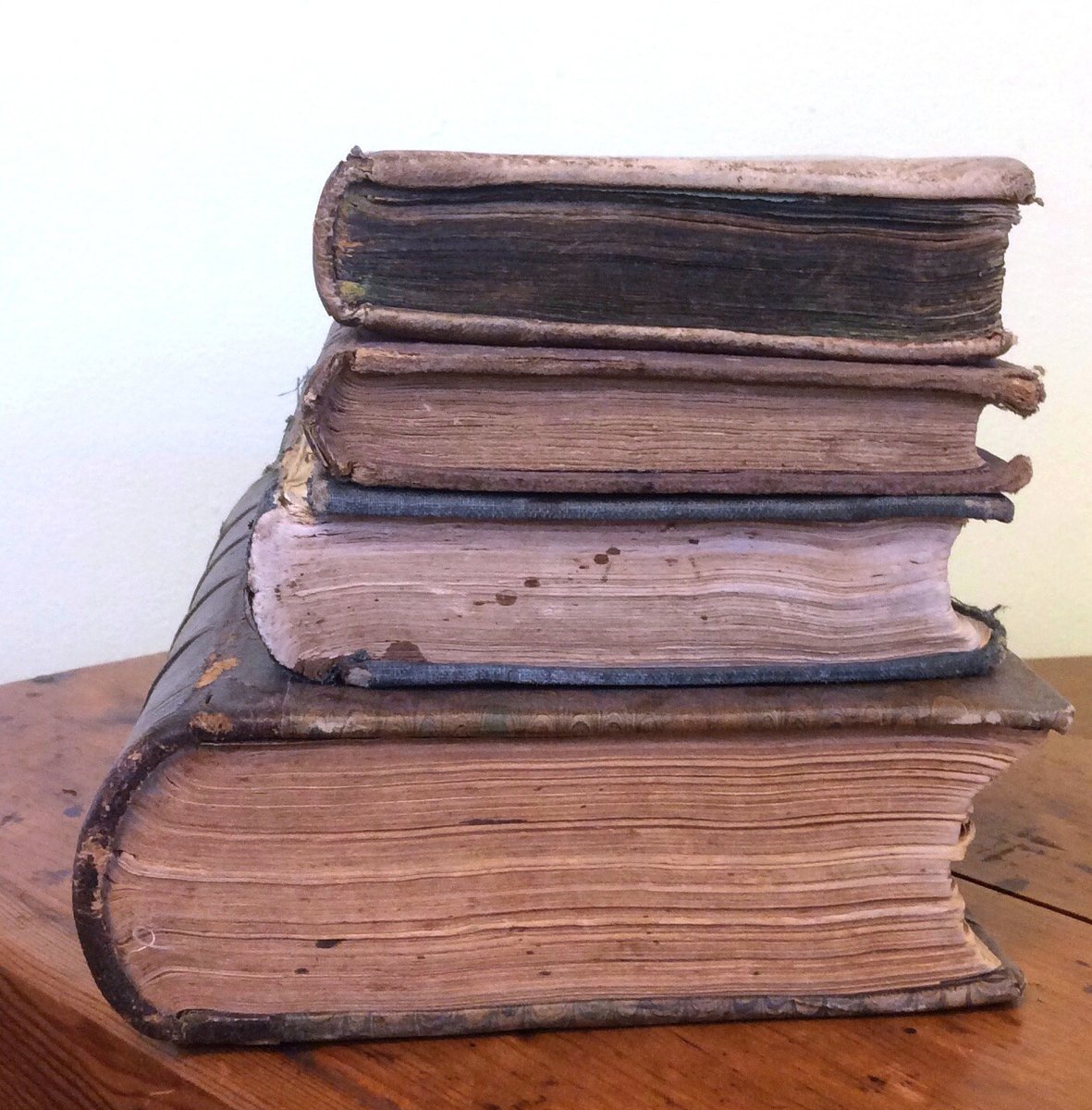 Four antique decorative books sold as a set